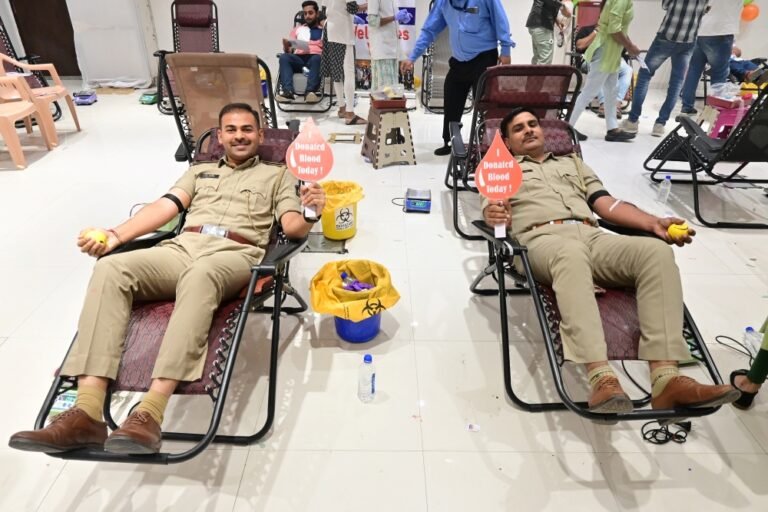 Police officers donating blood at Happy Faces Vadodara camp
