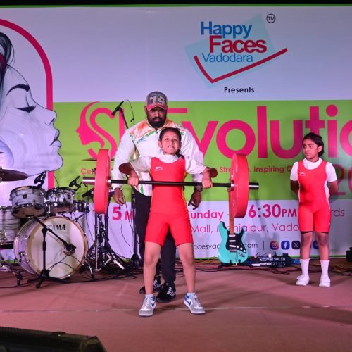Child weightlifting performance on stage Vadodara